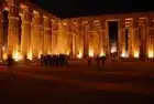 Philae Temple carved reliefs illuminated at night — Isis and Osiris myth depicted in stone